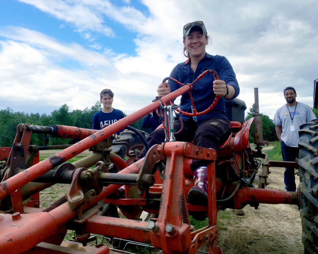 Alicia rides a tractor